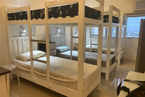 Bunk beds beside a window