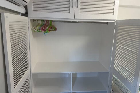Open wardrobe with a hanging rail and shelving below