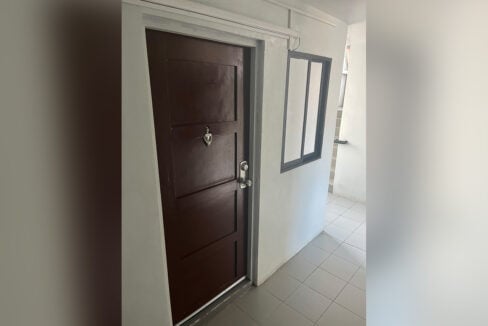 Front door of the Urban Deca Homes unit with a window to the corridor