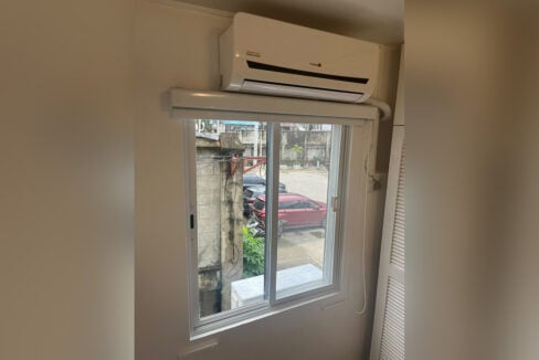Bedroom window with a split-type aircon above
