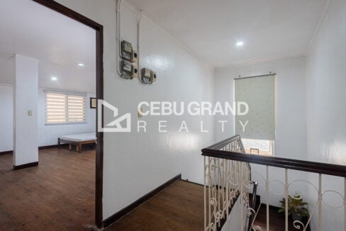 Upstairs landing with wood-look floors leading into a bedroom