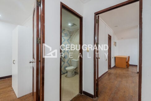Upstairs hallway with a bathroom between two bedroom doors