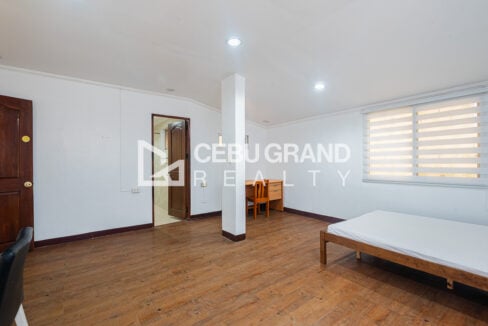 Large bedroom with a study desk and its own bathroom door