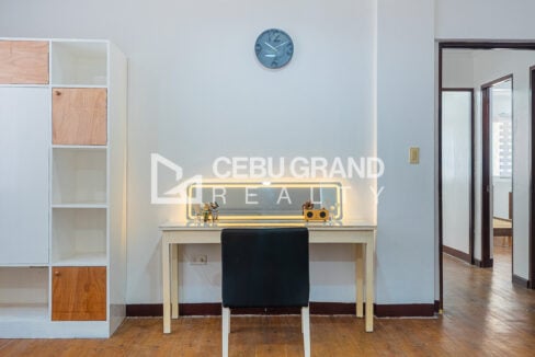 Vanity desk with an LED-lit mirror beside open shelving