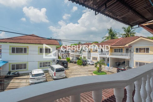 View from the balcony over the Banilad Town compound courtyard and parked cars