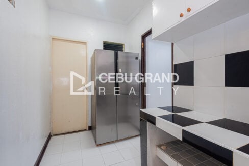 Side-by-side refrigerator beside the tiled kitchen counter