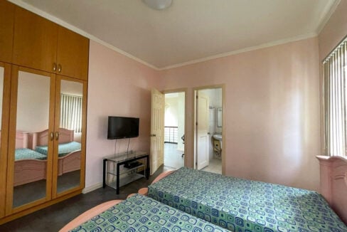 Bedroom with mirrored wardrobes and a door to the en-suite bathroom