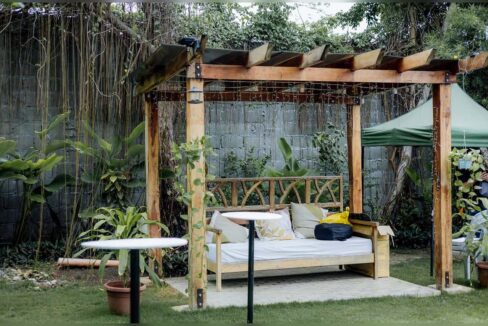 Wooden pergola with a daybed in a quiet corner of the garden