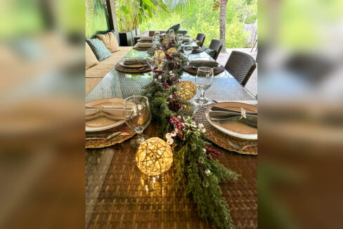 Dining table set with glassware and a garland centerpiece in the restaurant