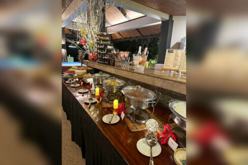 Pool bar with a granite counter and a buffet spread in the pavilion