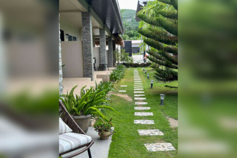 Stone-clad colonnade and garden lights lining a stepping-stone path