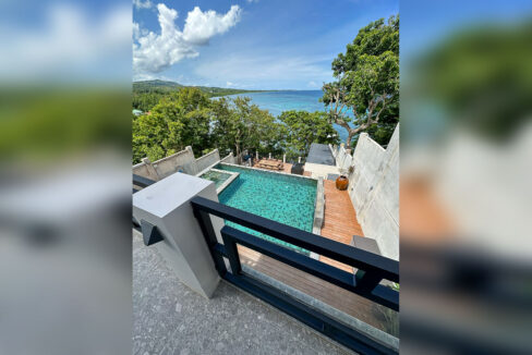 Aerial view of the infinity pool, deck and coastline of Talaga, Argao