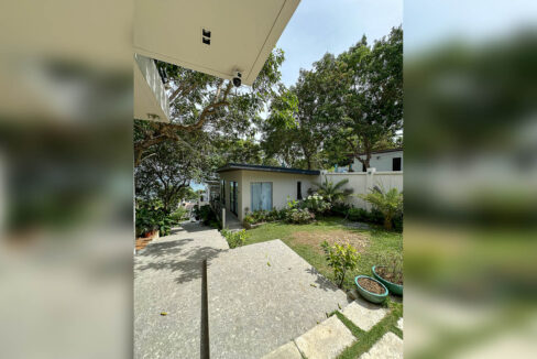 Garden cottage, lawn and terrazzo walkway inside the walled grounds