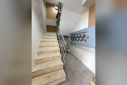 Stairwell with individual electric meters for each room on the wall