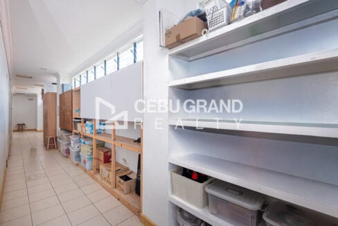 Corridor with built-in shelving and storage under clerestory windows