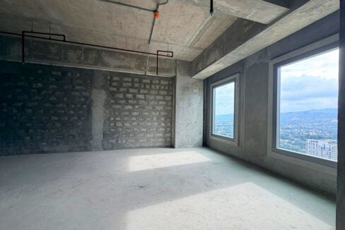 Open bare-shell floor with two large windows overlooking the hills and city of Lahug