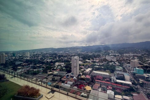 View deck with glass railing looking over Lahug toward the mountains