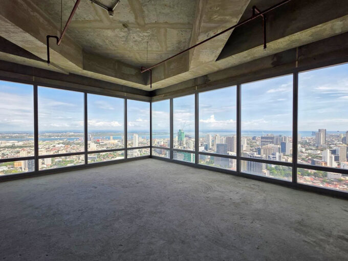 Corner office on the 38th floor of Cebu Exchange with floor-to-ceiling glass over the city and sea