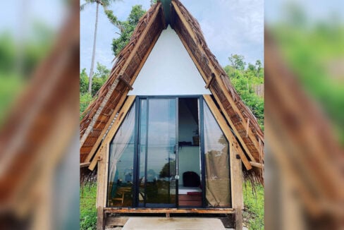 Nipa-thatched A-frame hut with full-height sliding glass doors