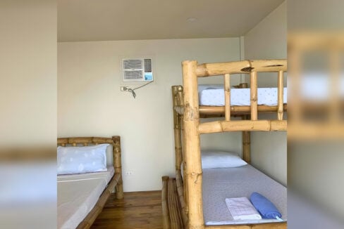 Bunk room with bamboo bunk beds and a window air conditioner