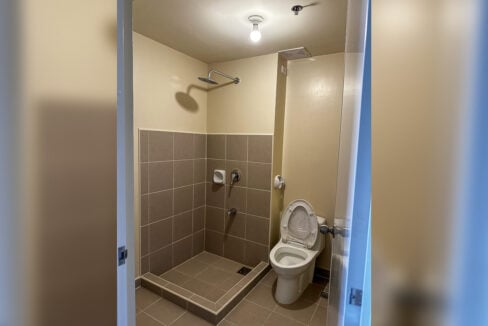 Bathroom with rain shower and tiled shower area