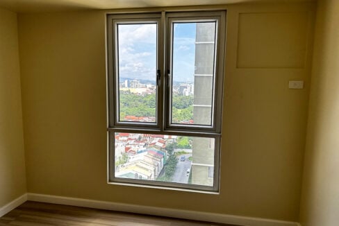 Casement window looking out over the treetops to the city