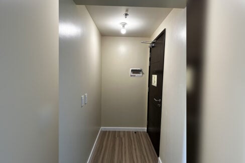 Entry foyer with front door and breaker panel