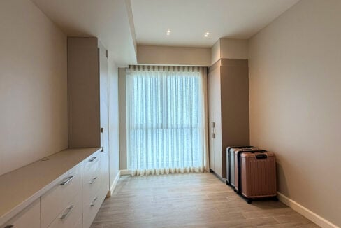 Second bedroom lined with built-in wardrobes and drawer counter