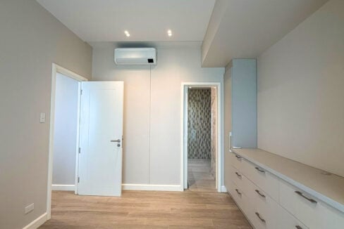 Second bedroom with split-type aircon and door to its bathroom