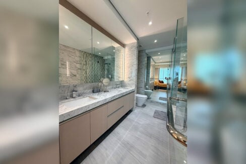 Master bathroom with double marble vanity and lit mirror cabinet
