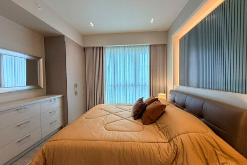 Master bedroom with leather headboard and backlit slatted feature wall