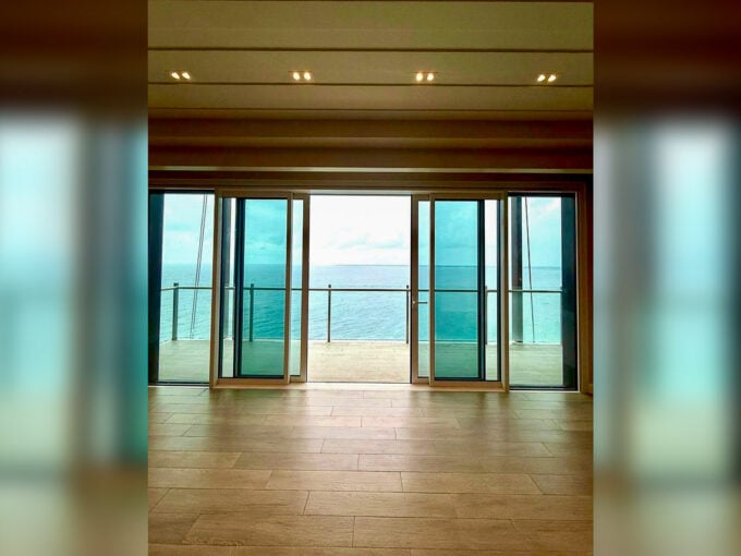 Full-height sliding glass doors opening to the balcony and sea view at Aruga, Mactan