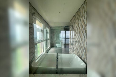 Master bathroom at Aruga with a freestanding soaking tub and glass rain shower