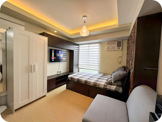 Furnished studio condo for sale at Avida Tower 2 with bed, TV wall, wardrobe and cove-lit ceiling
