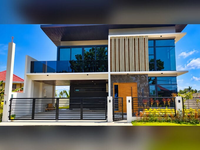 Modern house and lot for sale at Corona del Mar, Talisay City with glass balcony and wood-slat facade