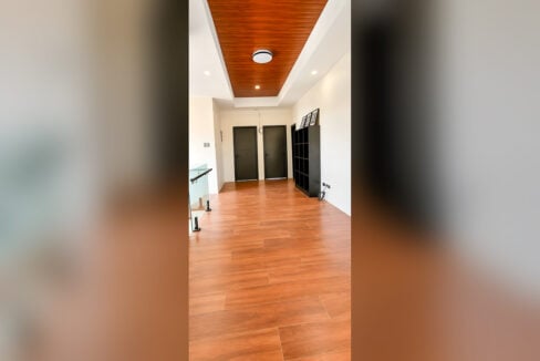 Upstairs hallway with wood ceiling cove, wood-look floor and bedroom doors