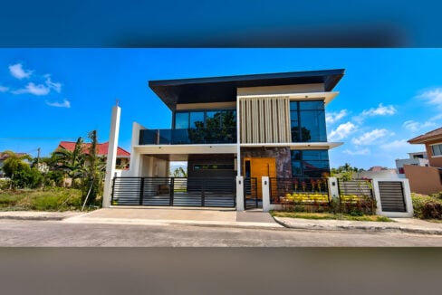 Street view of the modern two-storey house with black slatted gate and fence at Corona del Mar