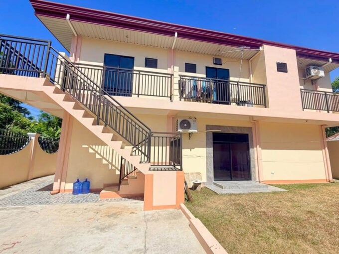 Two-storey house and lot for sale in Cordova, Cebu, with an outdoor stair to the upper balcony