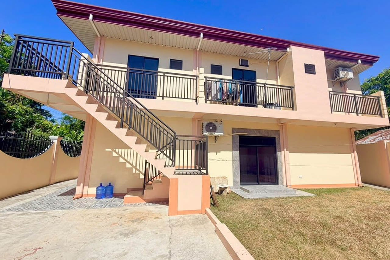 Two-storey house and lot for sale in Cordova, Cebu, with an outdoor stair to the upper balcony