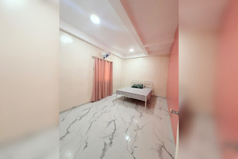 Bedroom with marble-look floor tiles and a metal bed frame