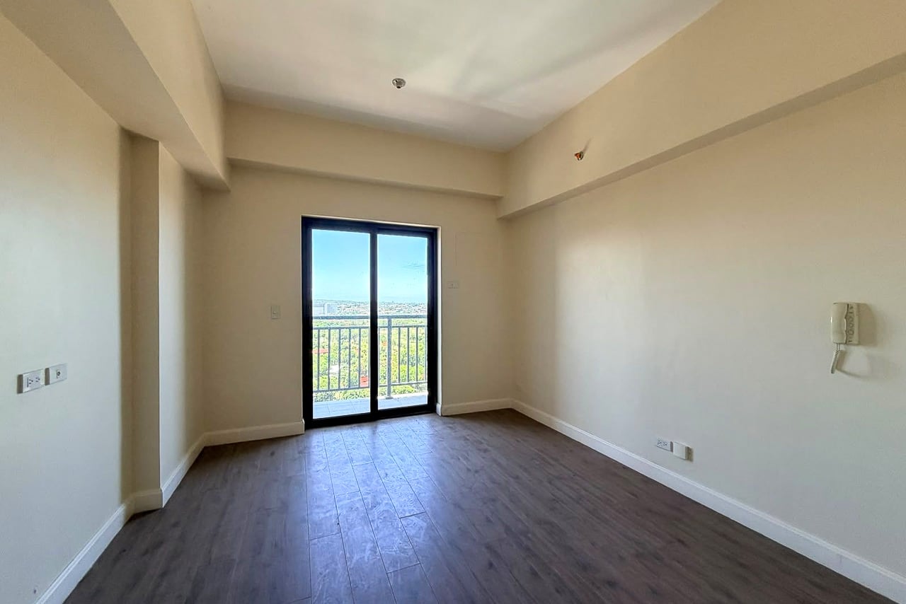 Brand-new studio for sale at Grand Residences, Cebu, with a glass door to the balcony