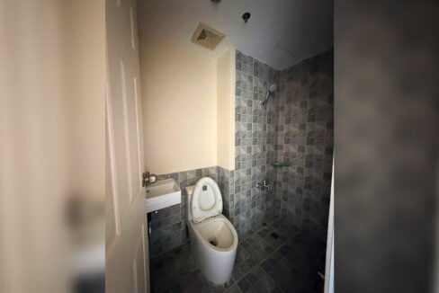 Bathroom in grey square tiles with a rain shower and wall-hung basin