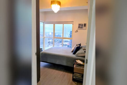 Master bedroom seen from the doorway, under a crystal chandelier