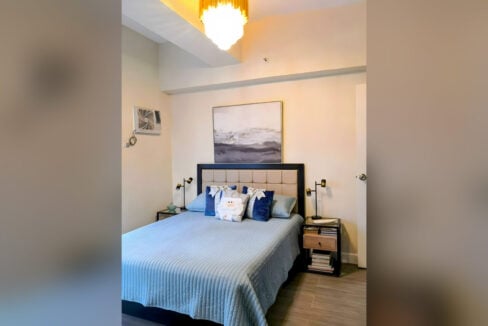 Master bedroom with a tufted headboard and glass-top bedside tables