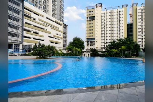 Swimming pool at Grand Residences with the residential towers behind