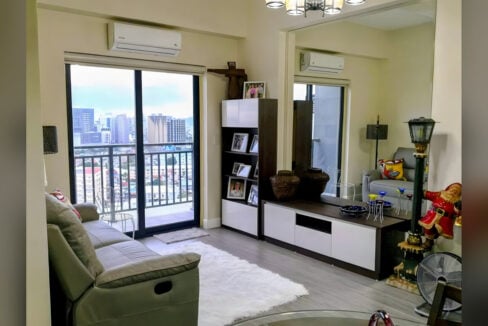 Living room at Grand Residences with a balcony door and city view