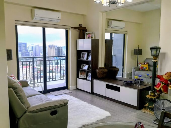 Living room at Grand Residences with a balcony door and city view
