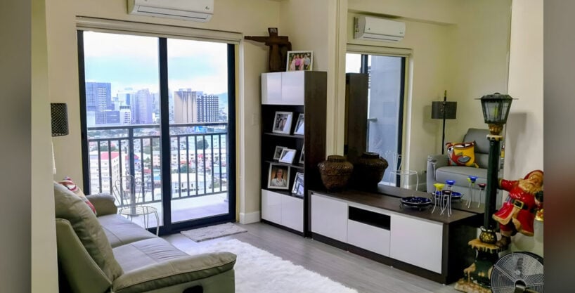 Living room at Grand Residences with a balcony door and city view