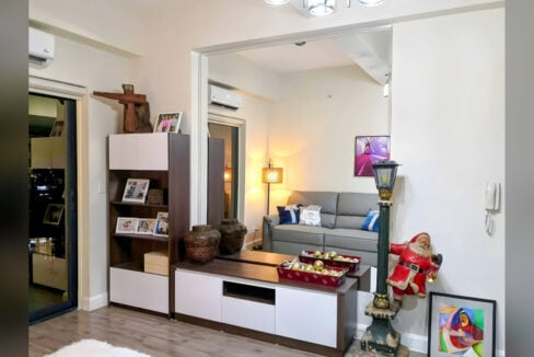 TV console and display cabinet beside a full-height mirror wall