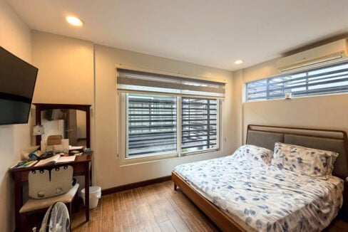Second bedroom with wall-mounted TV and split-type aircon